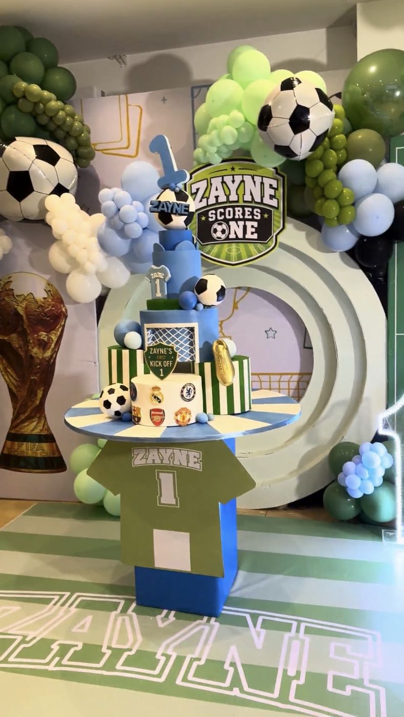 Football-themed first-birthday cake and balloon display